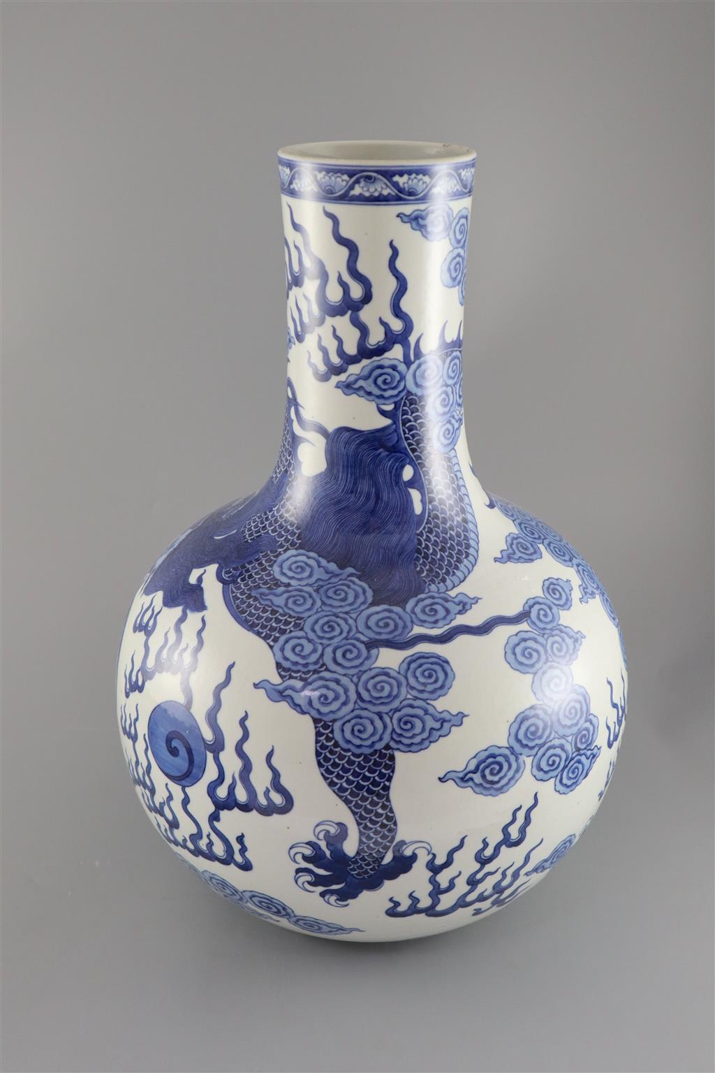 A large Chinese dragon bottle vase, Qianlong seal mark, probably late 19th century, 47cm high, wood stand